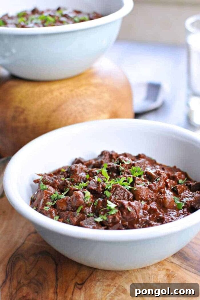 A white bowl of vegan slow cooker mole chili