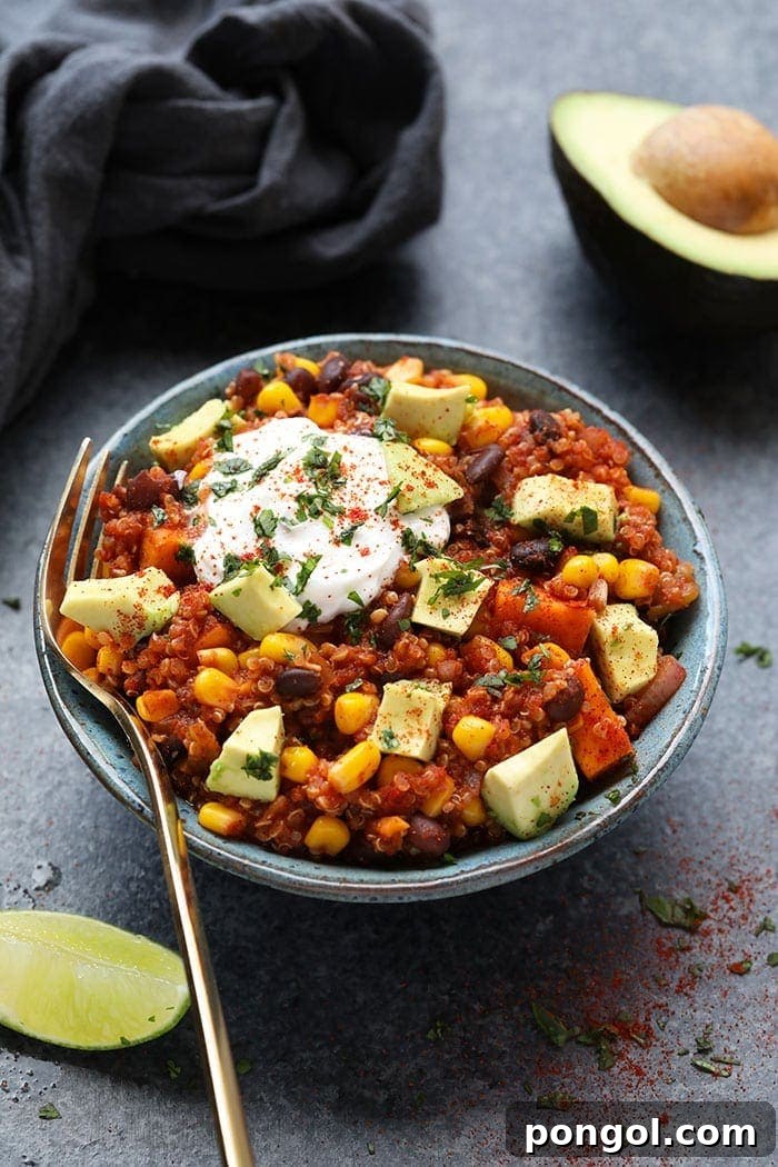 Vegetarian crockpot mexican quinoa in a grey bowl with a fork