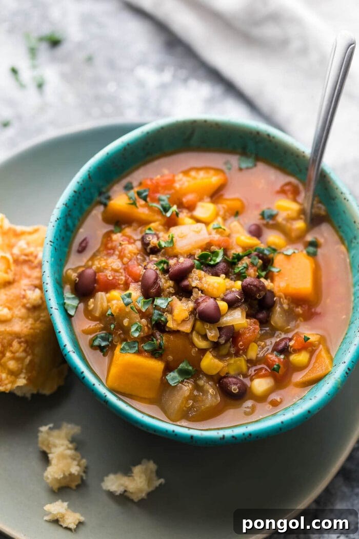 Vegetarian slow cooker black bean and quinoa stew with sweet potatoes in a blue bowl