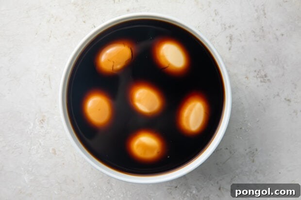 Soft boiled eggs marinating in a keto ramen marinade