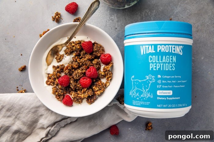 Vital proteins collagen peptides container next to a bowl of yogurt topped with granola and raspberries, illustrating a delicious serving idea