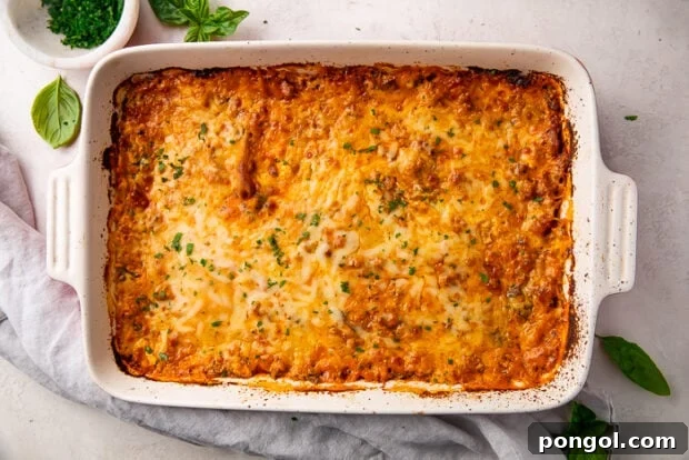 The Keto Lasagna Revelation 13 Baked keto lasagna in a ceramic baking dish, golden and bubbling hot from the oven.