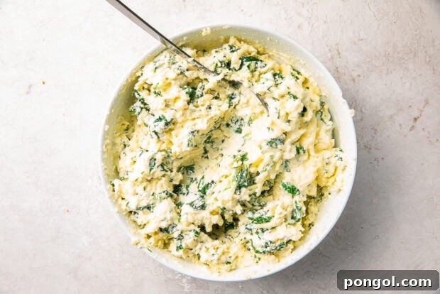 The Keto Lasagna Revelation 7 Spinach and ricotta mixture in a white mixing bowl, ready for layering.