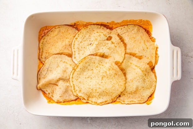 The Keto Lasagna Revelation 9 A baking dish with a base layer of keto lasagna meat sauce, topped with neatly arranged egg thin crepinis.