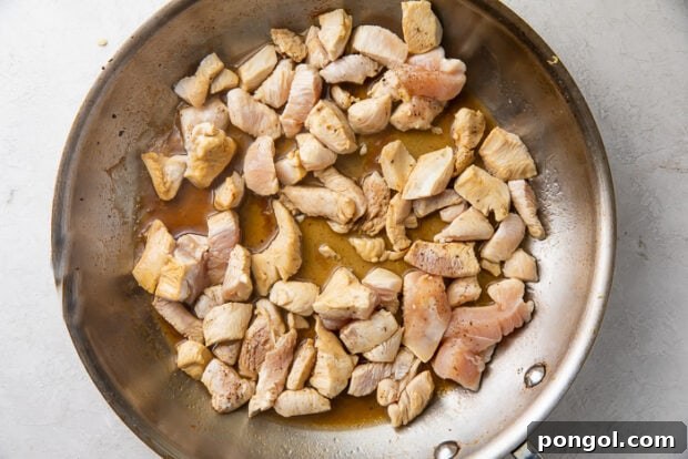 Chicken chunks sauteed in soy sauce in a large skillet