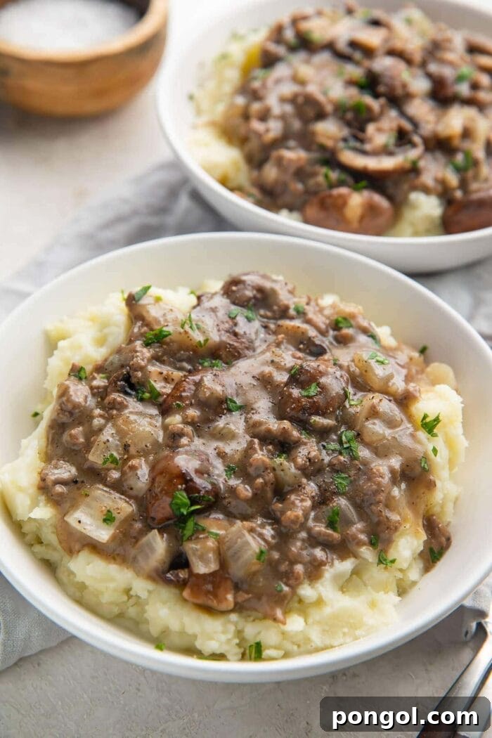 Plated whole30 beef stroganoff with mushroom gravy on top of mashed potatoes