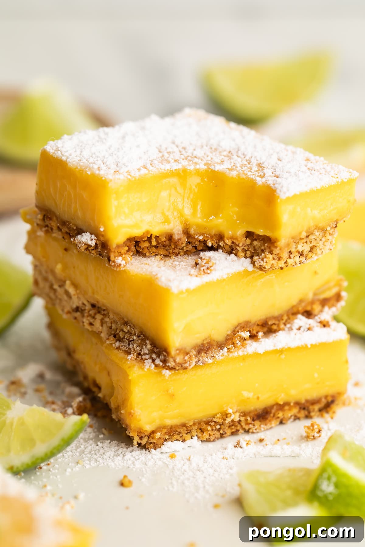 3 paleo lime bars stacked on top of each other. The top bar has a corner missing with teeth marks.