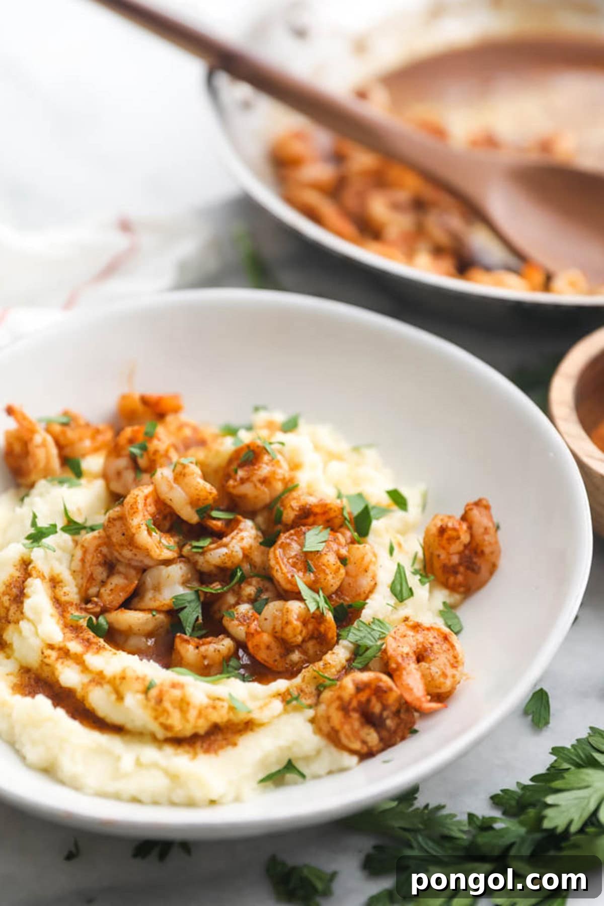A bowl of paleo Cajun shrimp on a bed of cauliflower grits.