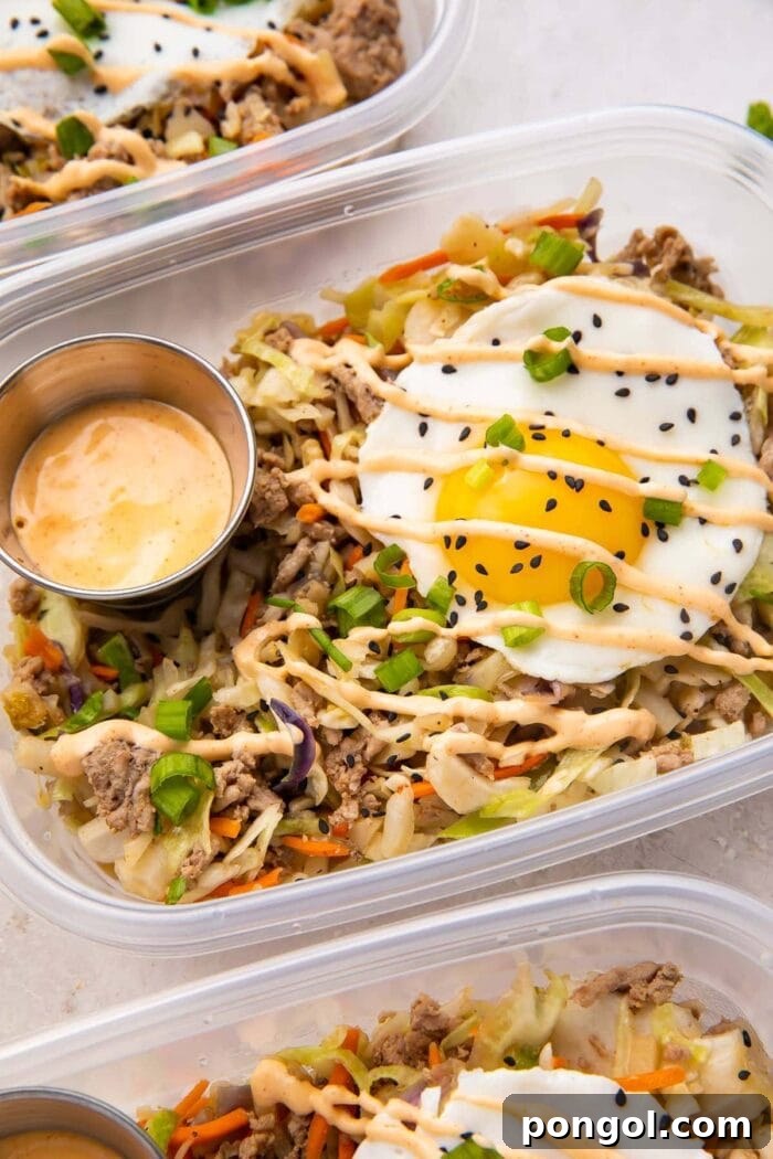 Close up of Egg roll in a bowl with a fried egg in meal prep containers
