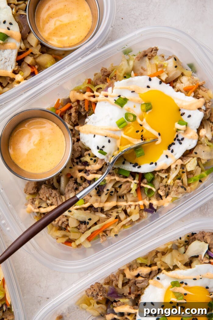 Egg roll in a bowl with a fried egg in meal prep containers