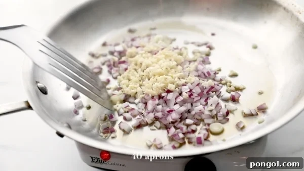 Onions and garlic sauteed in a large skillet