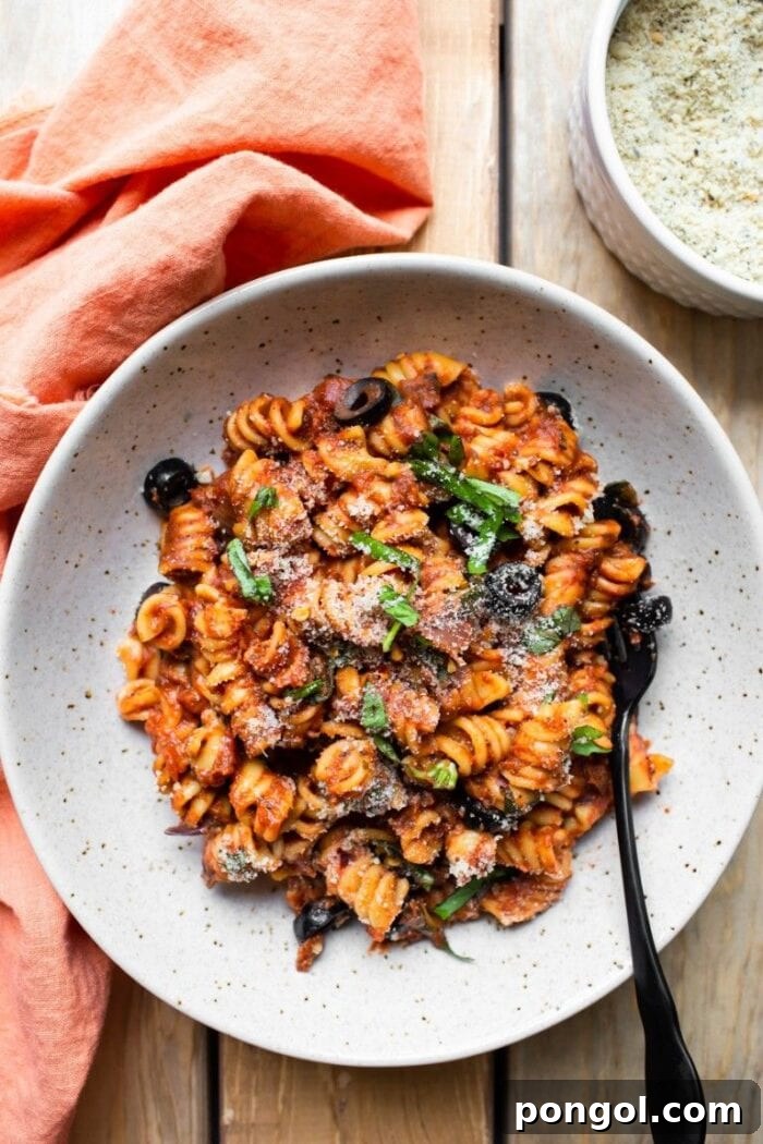 An eggshell white bowl filled with fragrant Instant Pot vegan Italian pasta, showcasing a wholesome and appealing meal.
