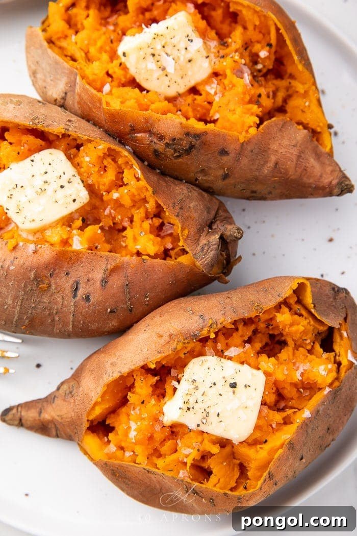 Three perfectly baked Instant Pot sweet potatoes, each topped with a pat of dairy-free butter, ready to be enjoyed.