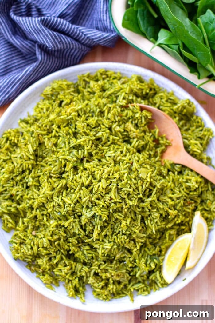A white plate showcasing fragrant spinach rice (Indian Palak Pulao), served with a wooden spoon and a blue towel.