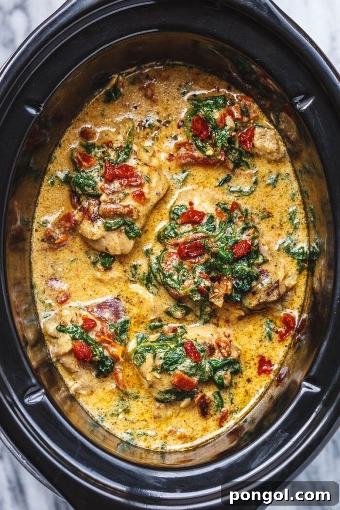 Tuscan chicken with spinach and sun-dried tomatoes in a crockpot bowl