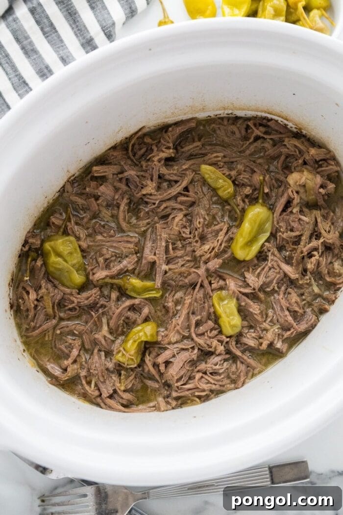 Slow cooker pot roast in a white slow cooker dish