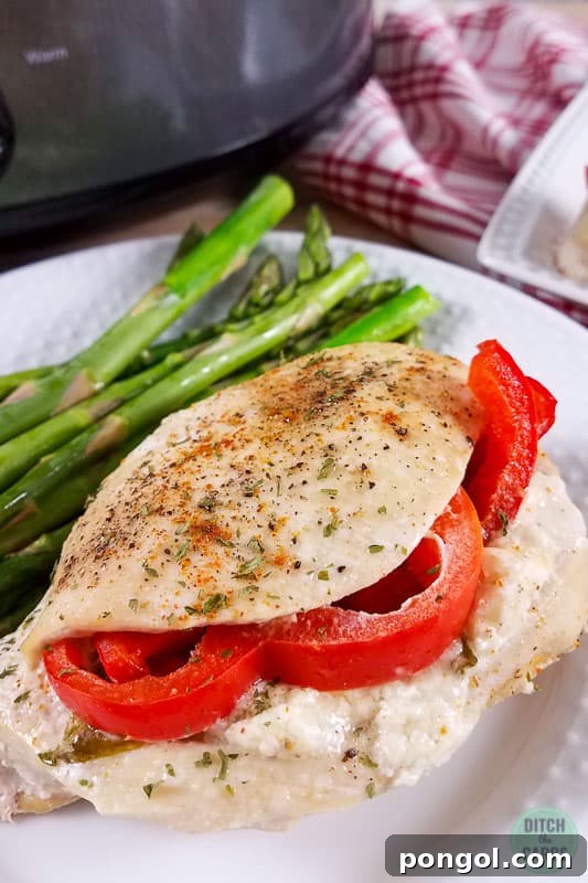 Chicken breast stuffed with tomato and cheese on a white bowl