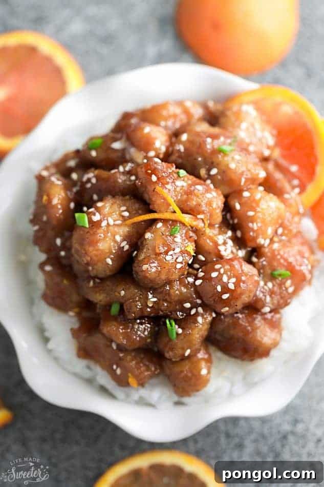 Keto orange chicken on a white scalloped plate
