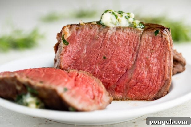 Medium rare sous vide filet mignon topped with herb butter