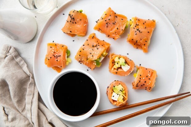 A stunning display of beautifully sliced keto smoked salmon sushi rolls, showcasing the vibrant and perfectly layered fillings