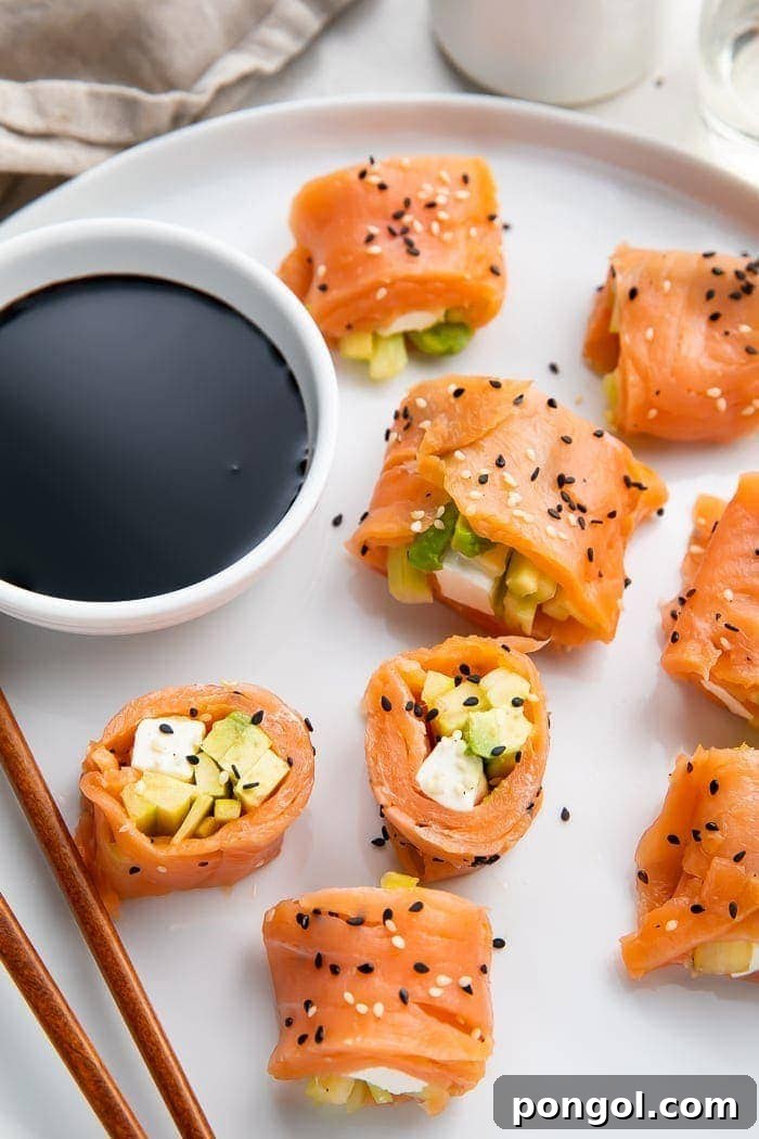 Eight pieces of perfectly cut keto smoked salmon sushi on a white plate, accompanied by elegant chopsticks and a small bowl of savory soy sauce