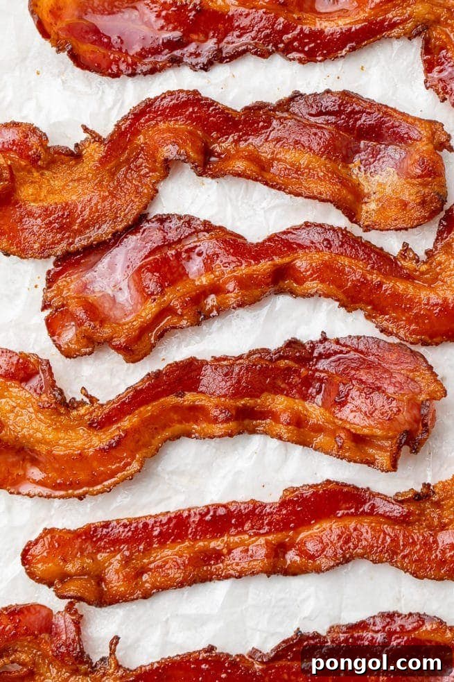 30 Delicious Keto Air Fryer Recipes 11 6 strips of air fried bacon on a sheet of parchment paper