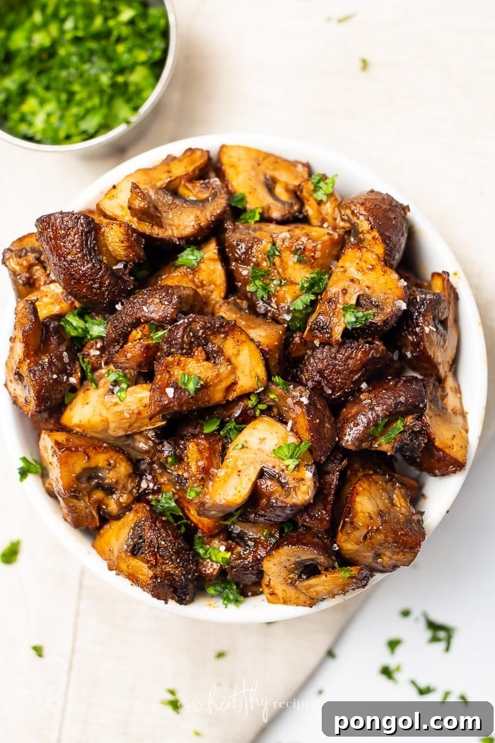 30 Delicious Keto Air Fryer Recipes 17 A white bowl of air fried mushrooms on a white countertop
