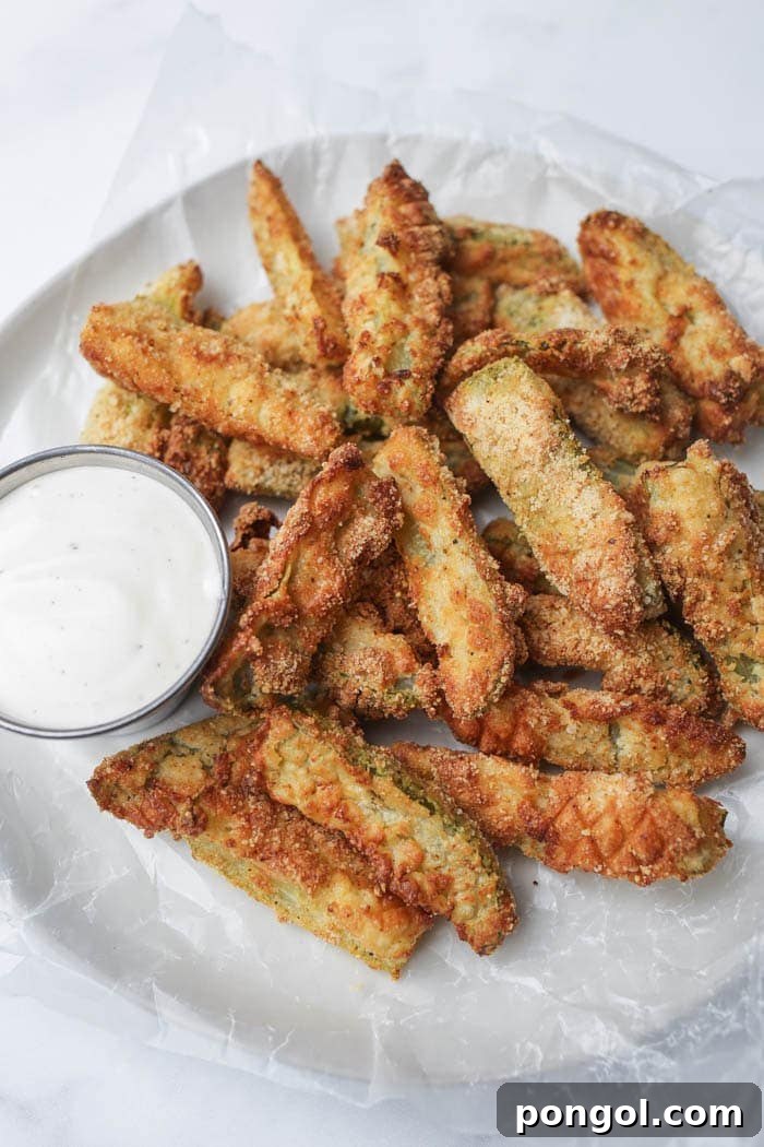 30 Delicious Keto Air Fryer Recipes 19 Air fried pickles on a white plate with a side of ranch