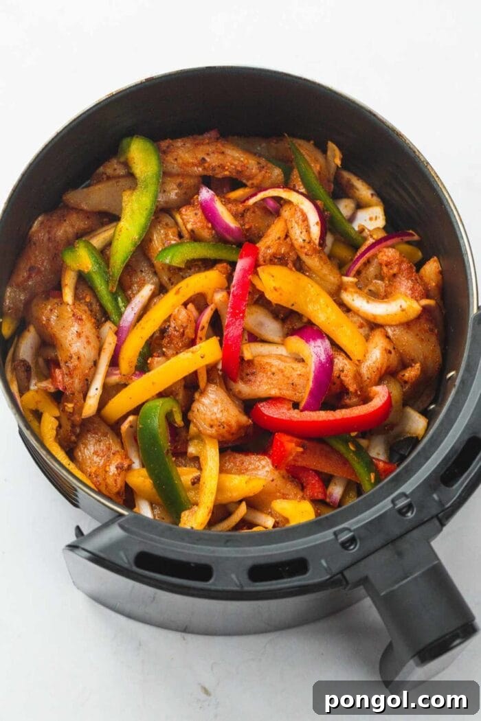 30 Delicious Keto Air Fryer Recipes 31 Keto chicken fajitas and peppers in an air fryer basket