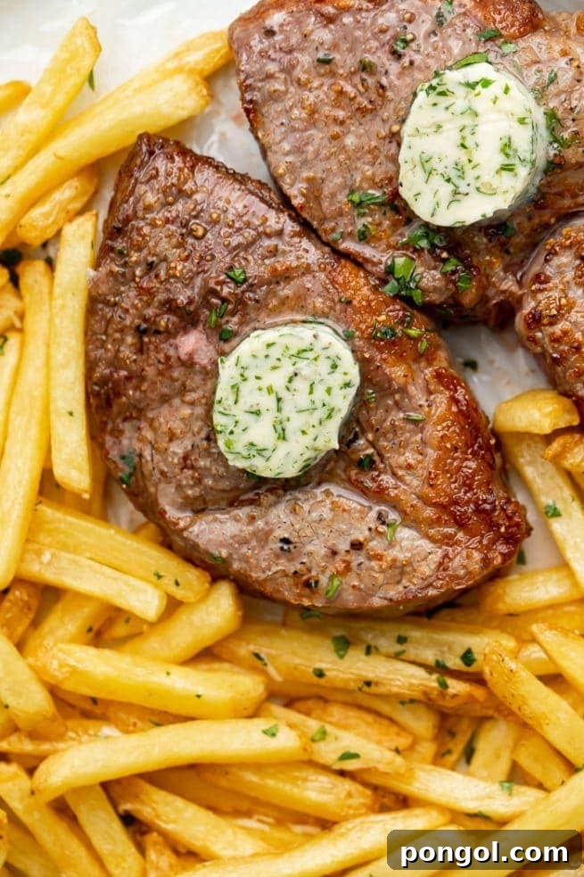 30 Delicious Keto Air Fryer Recipes 5 Two air fried steaks topped with herb butter with a side of fries