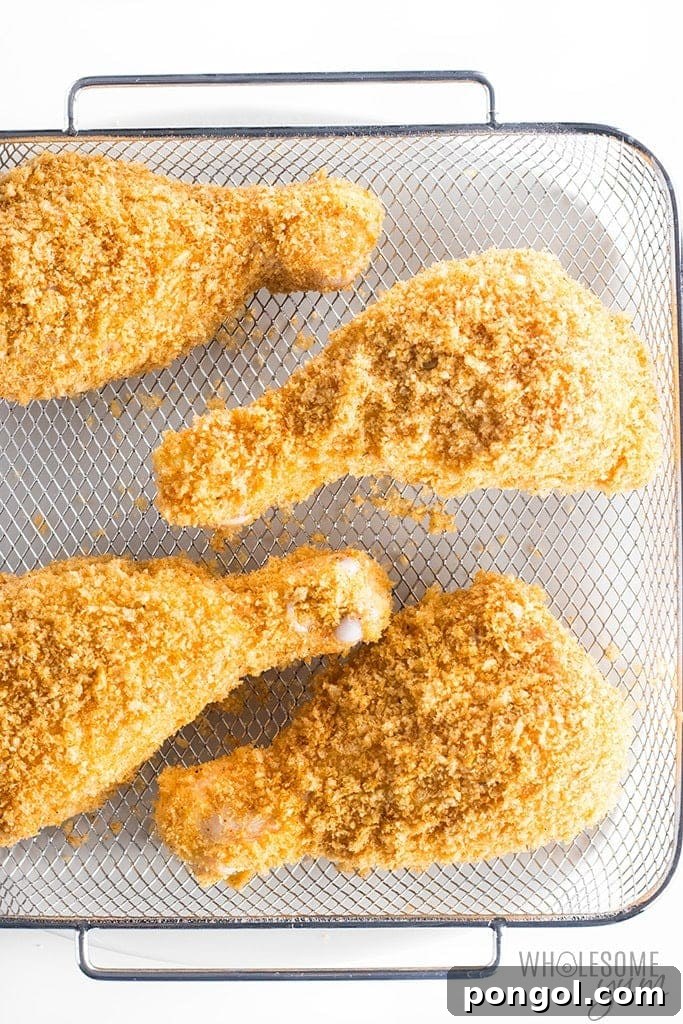 30 Delicious Keto Air Fryer Recipes 8 Fried chicken legs on an air fryer rack