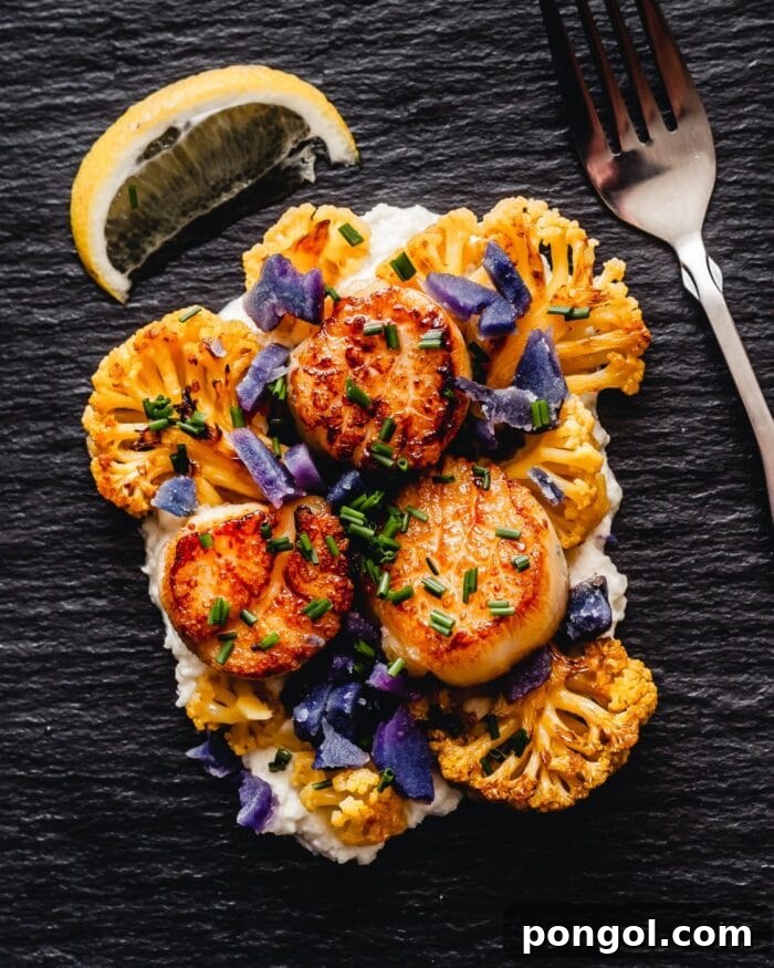 Sous vide scallops, tender cauliflower, and a luxurious brown butter tahini sauce arranged on a dark surface