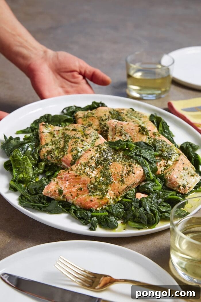 Sous vide salmon in fragrant herb butter, served on a bed of fresh spinach