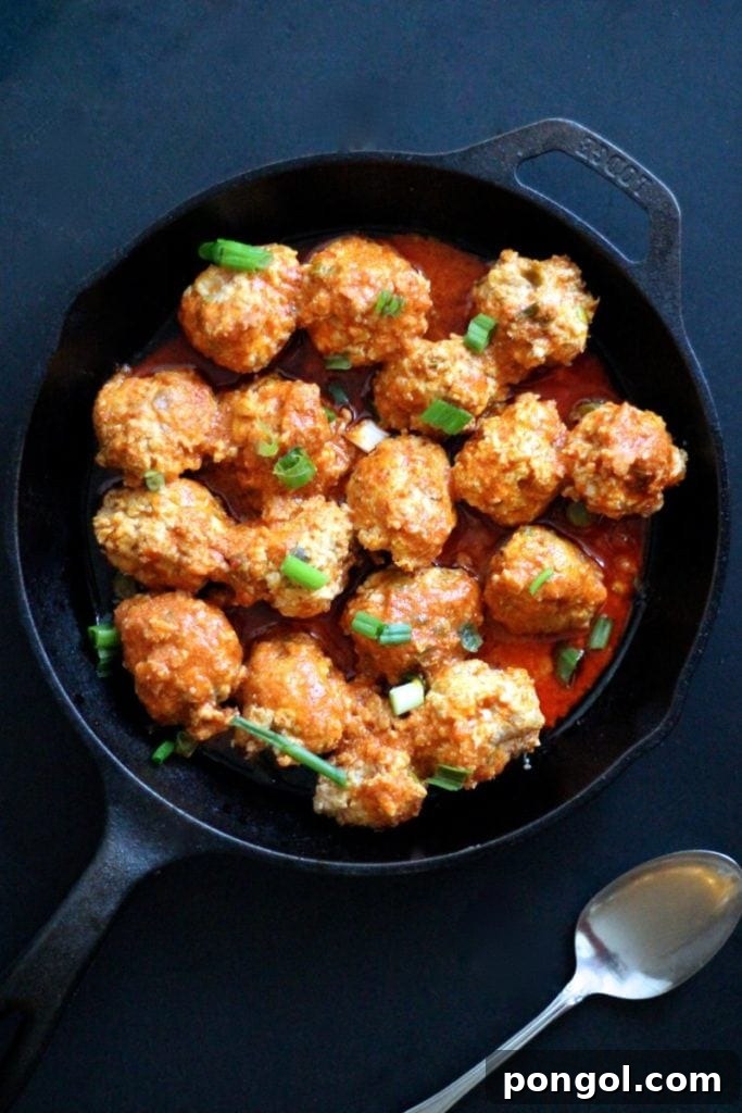 A cast iron skillet holding low carb meatballs cooked in the Instant Pot