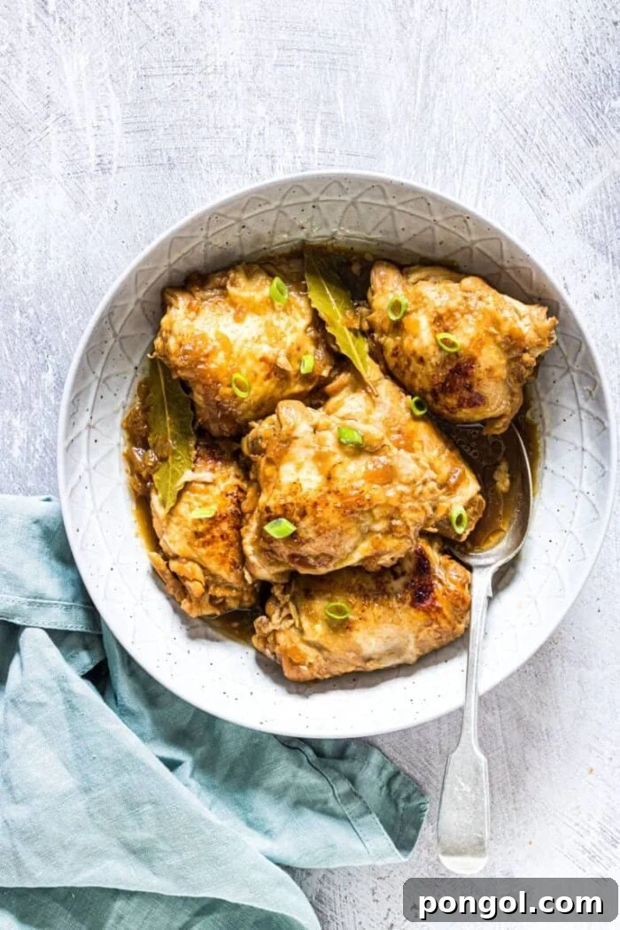 Large white bowl holding chicken adobo