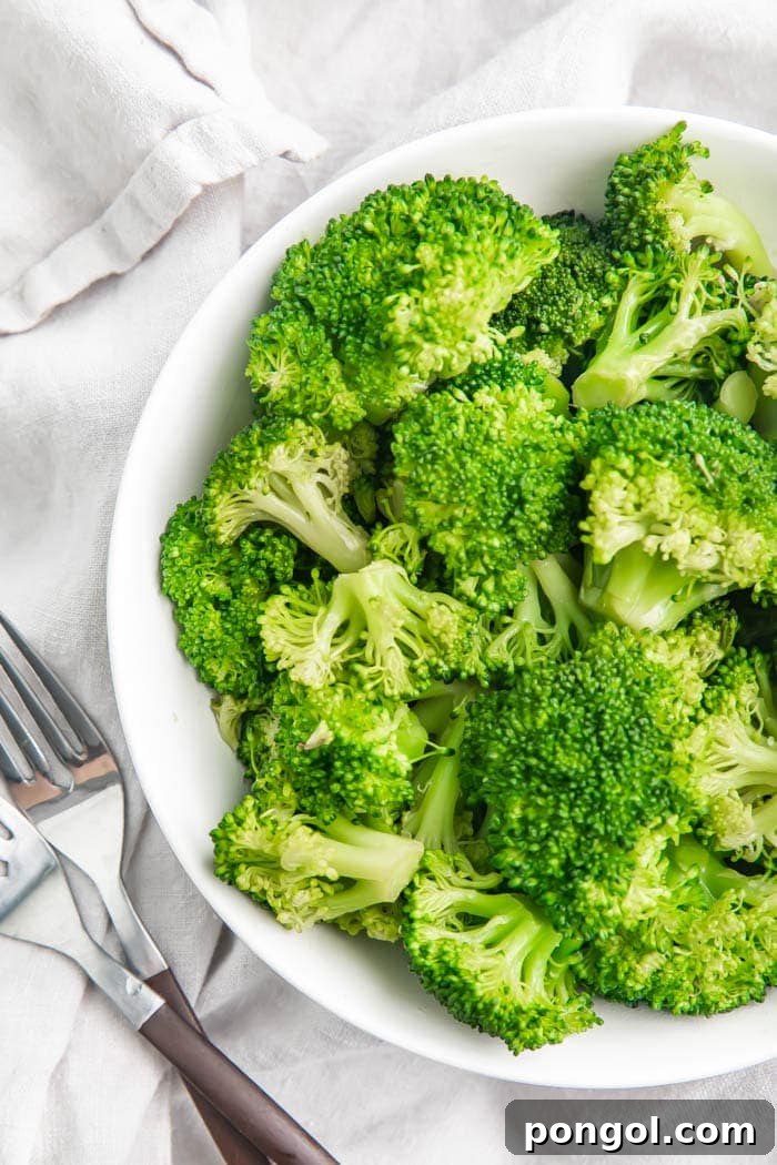 Overhead partial view of broccoli in a white bowl