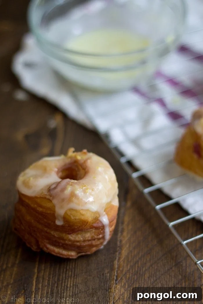 Pillowy Vegan Flaky Doughnuts with Blackberry Cream Cheese and Zesty Lemon Glaze 2 Close-up of a stack of Vegan Flaky Donuts, highlighting their impressive layers and golden-brown exterior.