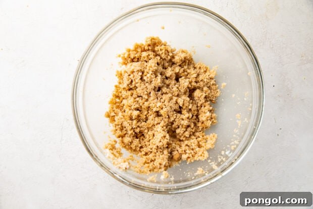 Ultimate Vegan Chocolate Chip Cookies 6 Vegan butter and sugars being creamed together in a glass mixing bowl with a hand mixer.