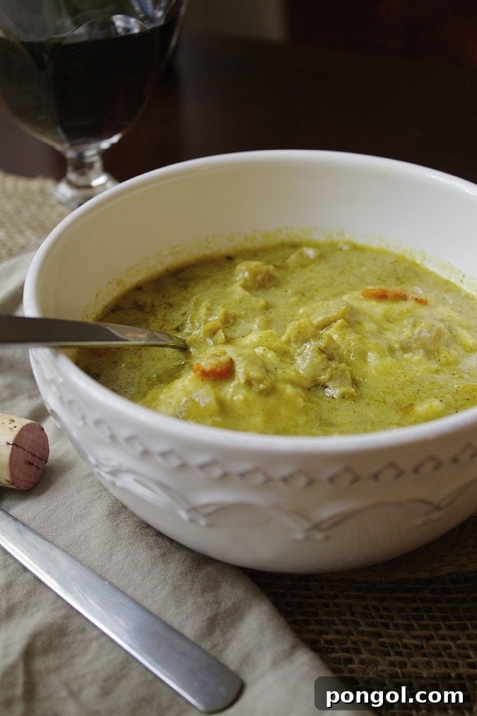 Delicious, steaming chicken and dumplings in a bowl, garnished with fresh parsley