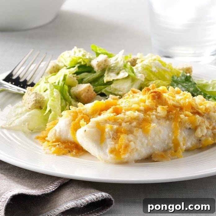Fish and Caesar salad on a white plate, highlighting a fresh orange roughy meal with classic flavors.