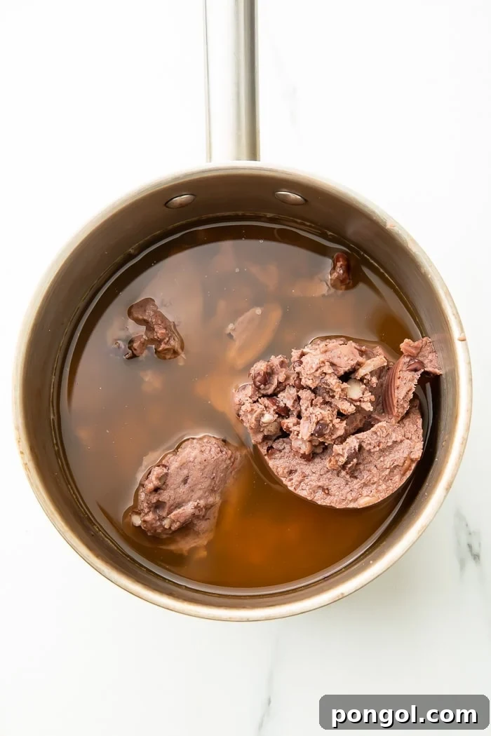 Speedy Black Bean Bliss 3 Black bean soup simmering gently in a pot on the stovetop.