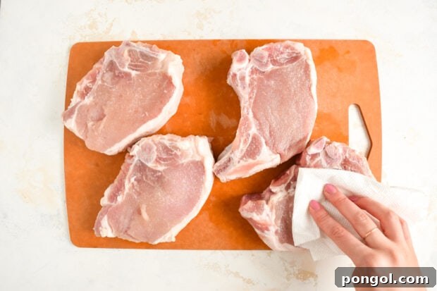 Brined pork chops removed from brine, patted dry, and ready to cook.