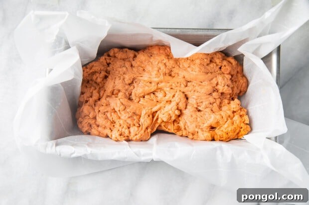 Homemade seitan in a loaf pan with parchment paper