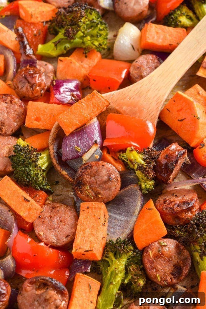 Sheet Pan Chicken Sausage with colorful vegetables on a baking sheet