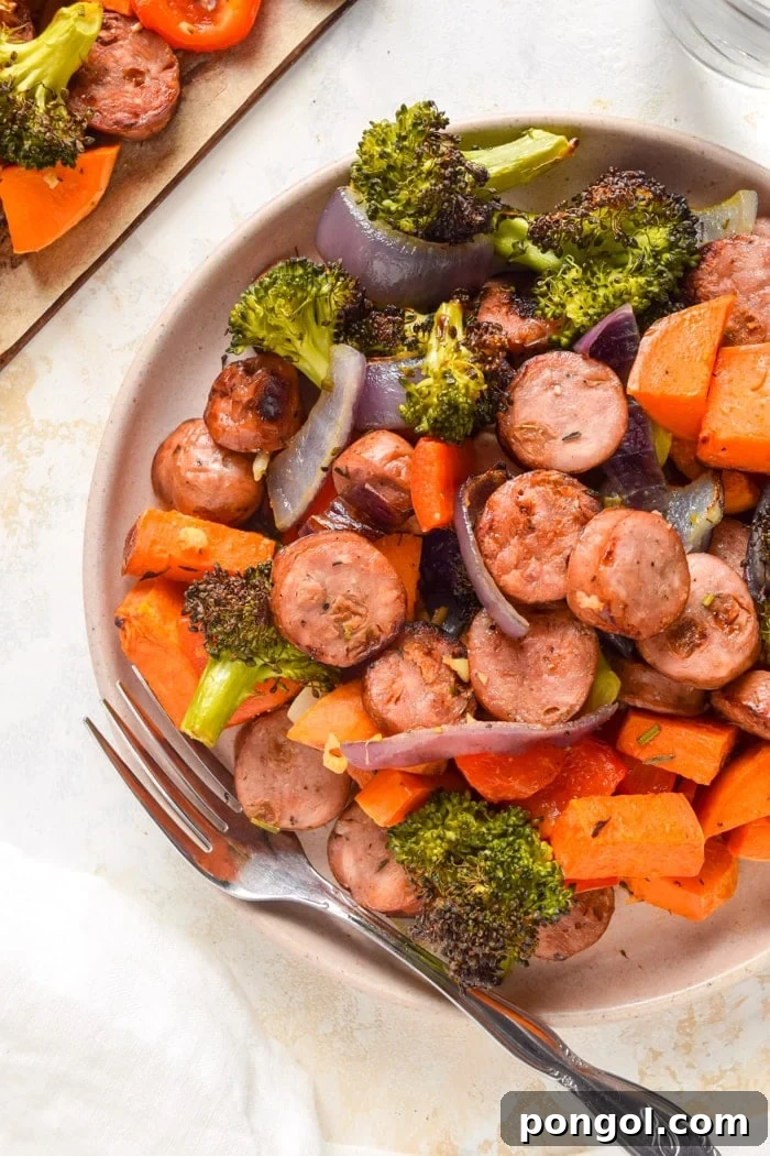 Cooked chicken sausage and roasted vegetables on a plate