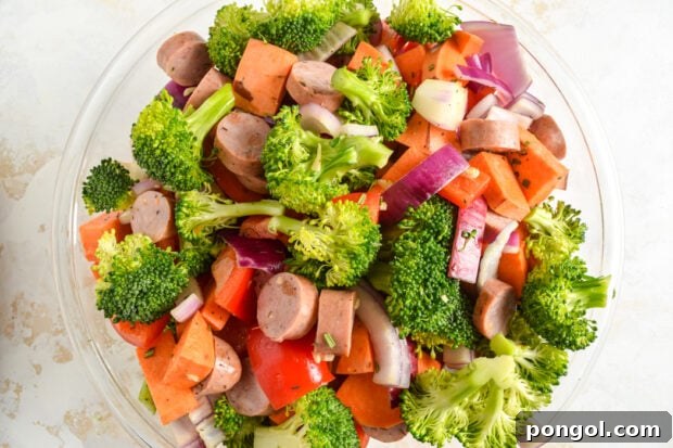 Ingredients being tossed in a large bowl with seasoning