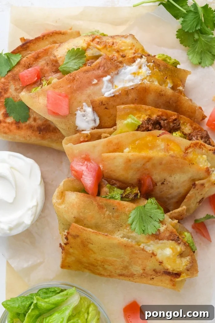 A vibrant spread of freshly cooked Mexican Tortilla Wraps (Crunchwraps), cut in half to reveal the rich, layered fillings, ready to be enjoyed