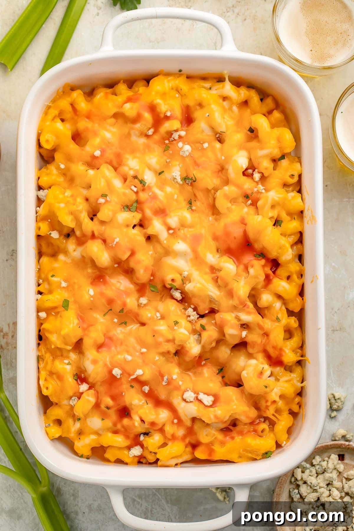 Overhead photo of a large white rectangular casserole dish holding a baked buffalo chicken mac & cheese.