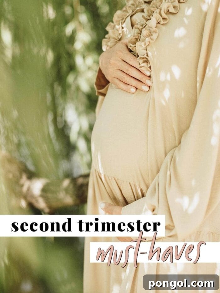 Pregnant woman smiling with a baby bump, showing off her second trimester journey.