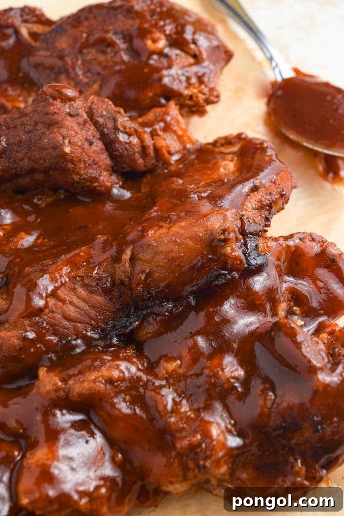 Perfectly cooked Instant Pot Country Style Ribs ready to be served, topped with barbecue sauce.